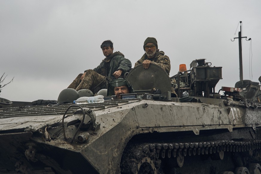 Ukrainian military vehicles move on the road in the freed territory in the Kharkiv region, Ukraine, Monday, Sept. 12, 2022. Ukrainian troops retook a wide swath of territory from Russia on Monday, pus ...