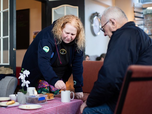 epa10368739 A volunteer prepares hot drinks for people at the Edge Centre warm bank in Tupton, Britain, 16 December 2022. According to fuel poverty charity National Energy Action, up to 6.7 million ho ...