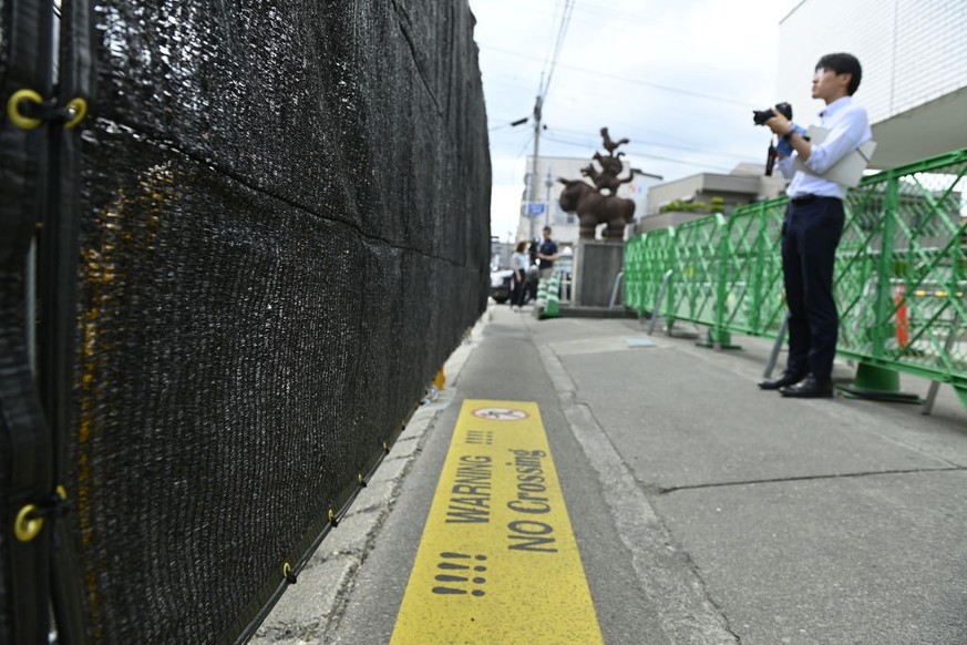 YAMANASHI PREFACTURE, JAPAN - MAY 21 : A member of media is seen covering on the street as The city of Fujikawaguchiko built a screen to dissuade tourists from taking photos of Mount Fuji, Japan&#039; ...