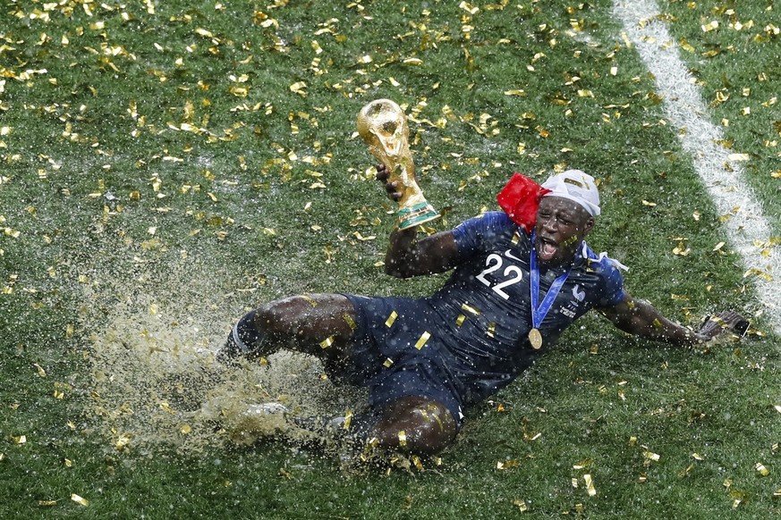 France&#039;s Benjamin Mendy celebrates with the trophy after his team won the final match against Croatia at the 2018 soccer World Cup in the Luzhniki Stadium in Moscow, Russia, on July 15, 2018. (AP ...