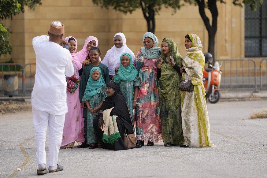 Muslim worshippers pose for a photograph after offering Eid al-Fitr morning prayer at the Mohammad al-Amin Mosque in downtown of Beirut, Lebanon, Monday, May 2, 2022. (AP Photo/Hassan Ammar)