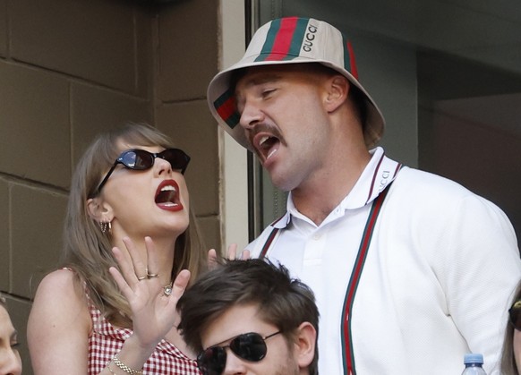 epa11593954 U.S. singer Taylor Swift (L), and American professional football player with the Kansas City Chiefs, Travis Kelce (R), sing along to tunes played during the change over during the men?s fi ...