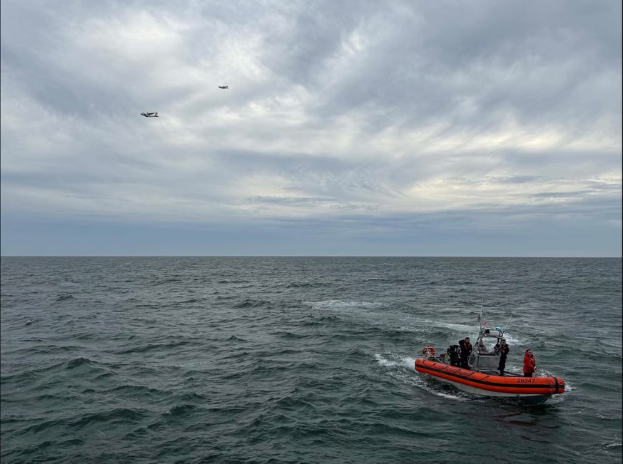 In this photo released by U.S. Coast Guard, crew members search by air and on the water for a Boston-bound air ambulance that vanished off the coast of Nantucket, Massachusetts, on Saturday, Oct. 3, 2 ...
