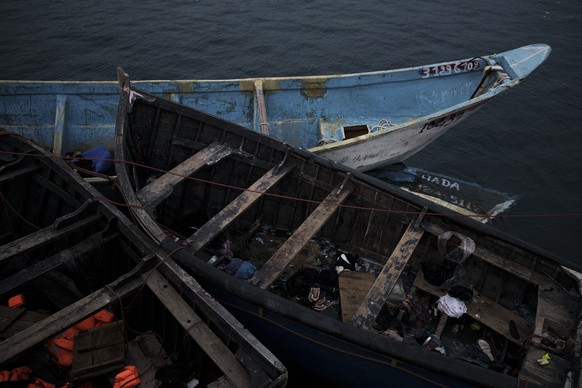 FILE - Empty boats used by migrants are moored at the port of Arguineguin in the Canary island of Gran Canaria, Spain, on Nov. 21, 2021. Spanish maritime rescuers say they have pulled 38 people alive  ...