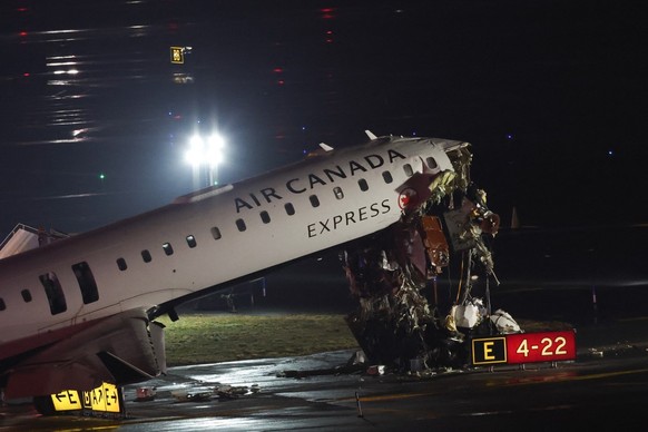 An Air Canada Express CRJ-900 sits on the runway after colliding with a Port Authority fire truck at LaGuardia Airport in New York, on March 23, 2026. Air Canada Express flight AC8646 originated from  ...