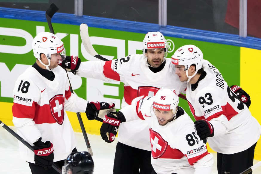From left, Switzerland's Sven Jung, Switzerland's Denis Malgin, Switzerland's Sven Andrighetto and Switzerland's Theo Rochette celebrate the first goal during the 2026 IIHF Men ...