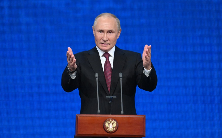 Russian President Vladimir Putin gestures while addressing an event marking the 100th anniversary of the republic of Adygea, Kabardino-Balkaria and Karachayevo-Circasia, at the State Kremlin Palace in ...