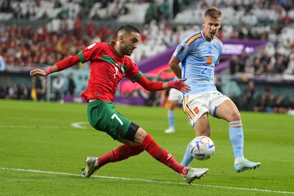 Morocco&#039;s Hakim Ziyech, left, and Spain&#039;s Dani Olmo compete for the ball during the World Cup round of 16 soccer match between Morocco and Spain, at the Education City Stadium in Al Rayyan,  ...