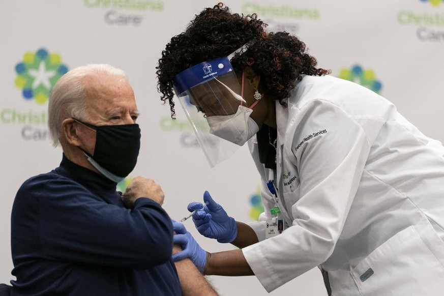 President-elect Joe Biden receives his first dose of the coronavirus vaccine from Nurse partitioner Tabe Mase at Christiana Hospital in Newark Del., Monday, Dec. 21, 2020, from nurse practitioner Tabe ...