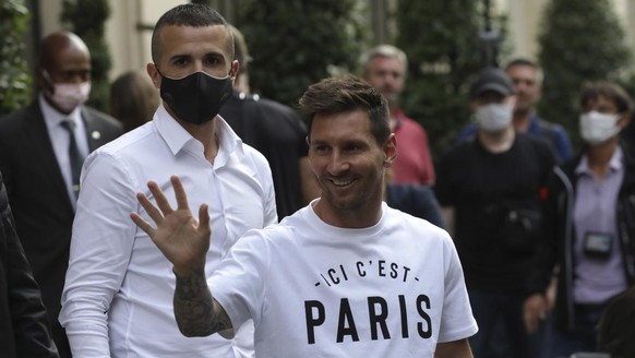 Argentinian soccer star Lionel Messi waves to supporters as he arrives at his hotel in Paris, Tuesday, Aug. 10, 2021. Lionel Messi finalized agreement on his Paris Saint-Germain contract and arrived i ...