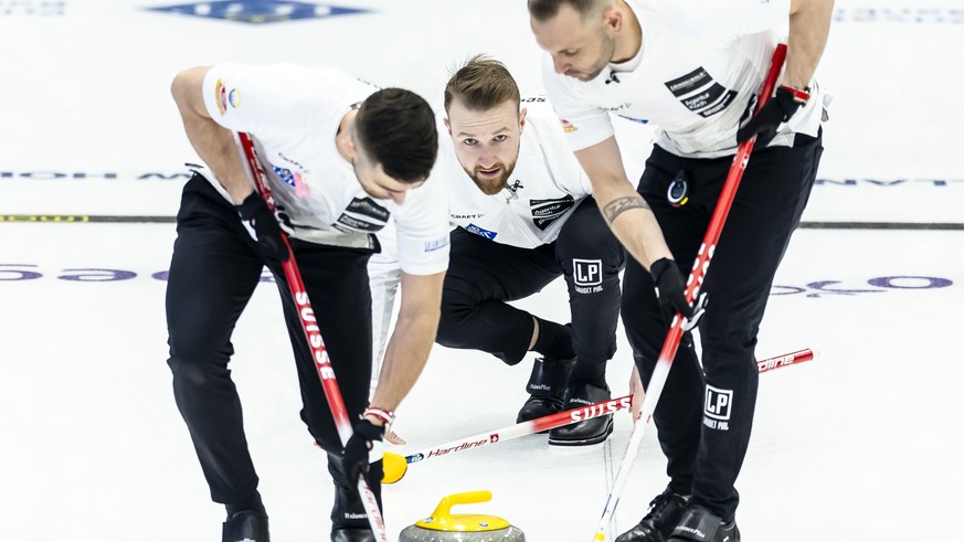 Switzerland&#039;s skip Yannick Schwaller, center, delivers a stone against Norway next to Sven Michel, right, and Pablo Lachat-Couchepin, left, at the World Men&#039;s Curling Championship at the IWC ...