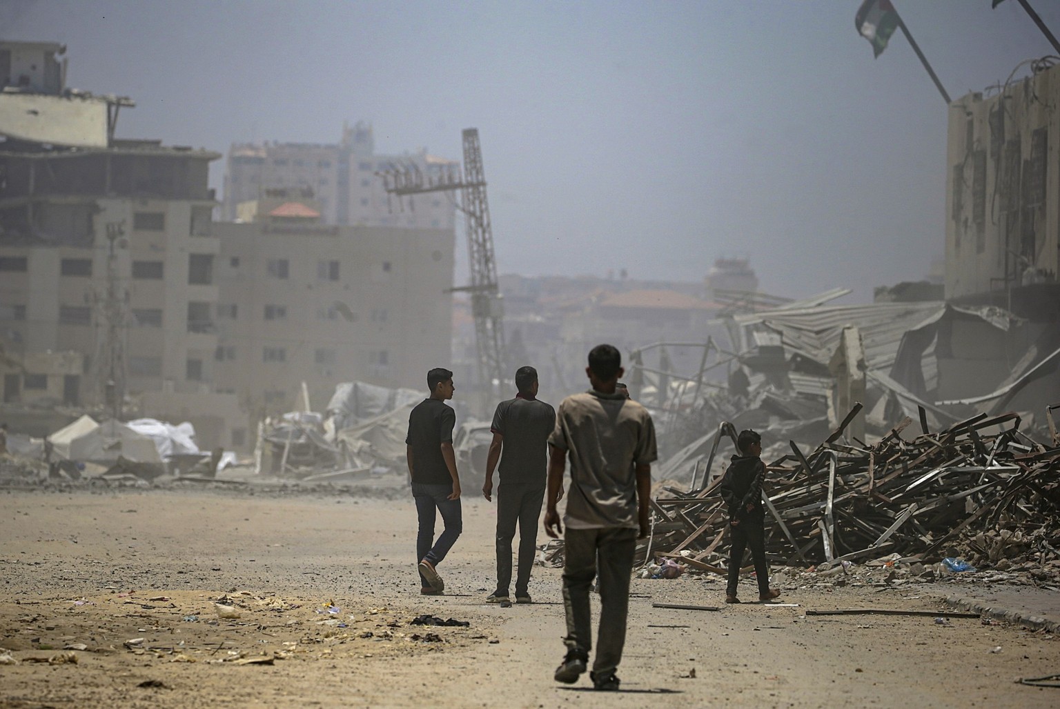 epa12128031 Internally displaced Palestinians inspect a destroyed building following an Israeli airstrike west of Gaza City, in Gaza Strip, 23 May 2025. More than 53,700 Palestinians have been killed  ...