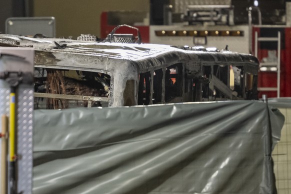 The charred shell of a postal bus pictured after catching fire in Kerzers, Switzerland, Tuesday, March 10, 2026. According to the Fribourg cantonal police, several passengers were killed and others in ...