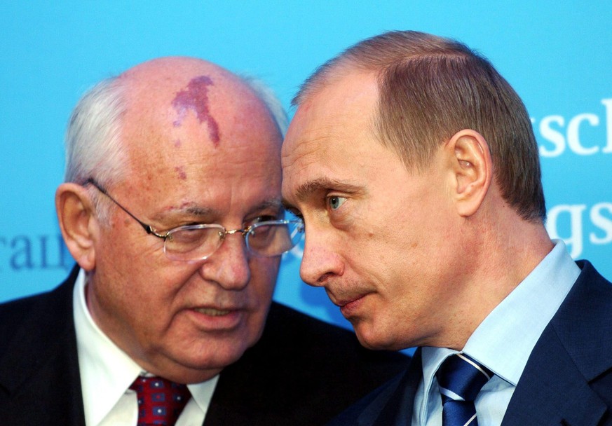 epa10148348 (FILE) - Russian President Vladimir Putin (R) and former Soviet leader Mikhail Gorbachev (L) talk during a press conference at Gottorf palace in the northern village of Schleswig, Germany, ...