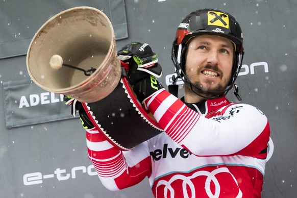 Winner Marcel Hirscher of Austria, celebrates with a Swiss Cow Bell on the podium after the second run of the men&#039;s slalom race at the Alpine Skiing FIS Ski World Cup in Adelboden, Switzerland, S ...