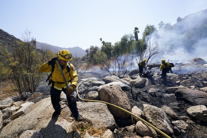 Cal Fire crews work a flare up near the Barrett Mobile Home and RV Park as they fight the Border Fire Thursday, Sept. 1, 2022, in Dulzura, Calif. California wildfires chewed through rural areas north  ...