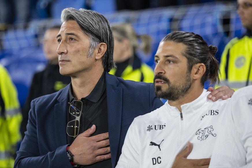 Switzerland's head coach Murat Yakin, left, and assistant coach Davide Calla look on during the national anthems, ahead of the FIFA 2026 World Cup Group B qualifying soccer match between Switzerl ...