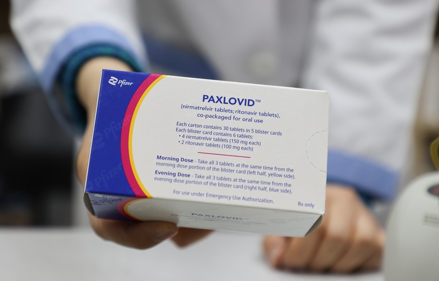 epa09775282 A pharmacist displays a case of Paxlovid, a COVID-19 treatment pills developed by Pfizer Inc., at a drugstore in Seoul, South Korea, 21 February 2022. The age restriction on the administra ...