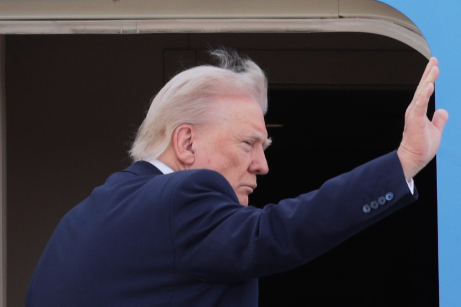 President Donald Trump waves from the stairs of Air Force One, upon his arrival at Joint Base Andrews, Md. Friday, April 25, 2025. The President and first lady are traveling to Rome and the Vatican to ...