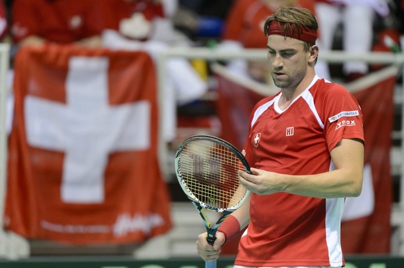 Swiss tennis player Michael Lammer racts after missing a point against Belgium tennis player Steve Darcis during the second match of the Davis Cup World Group - First Round, 1/8 final tennis match Bel ...