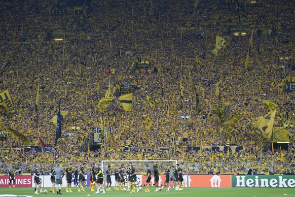 Dortmund players warm up ahead of the Champions League semifinal first leg soccer match between Borussia Dortmund and Paris Saint-Germain at the Signal-Iduna Park stadium in Dortmund, Germany, Wednesd ...