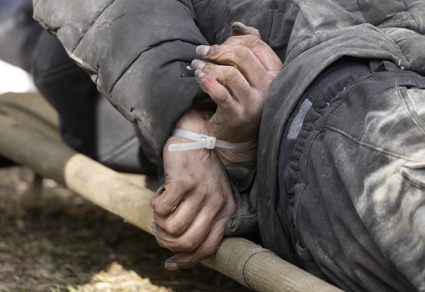 A dead civilian with his hands tied behind his back lies on the ground in Bucha close to Kyiv, Ukraine, Monday April 4, 2022. Russia is facing a fresh wave of condemnation after evidence emerged of wh ...