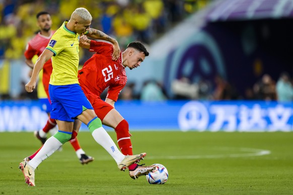 Brazil&#039;s forward Richarlison, left, fights for the ball with Switzerland&#039;s midfielder Fabian Rieder, right, during the FIFA World Cup Qatar 2022 group G soccer match between Brazil and Switz ...