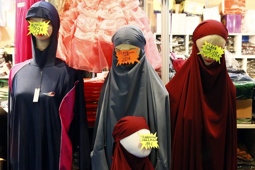 Islamic face-covering veils, burkini and clothes are displayed inside an exhibition hall at the France Muslim Annual Fair in Le Bourget, north of Paris, Saturday, April 15, 2017. Tens of thousands of  ...