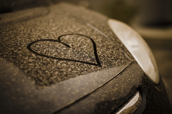 A drawn heart is seen on a black painted car covered with sahara dust, in Zurich, Switzerland on March 15, 2022. (KEYSTONE/Michael Buholzer)