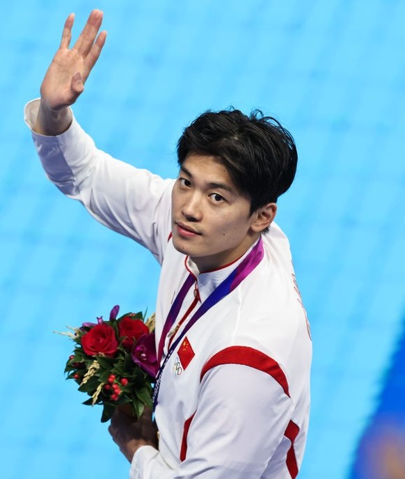 HANGZHOU, CHINA - SEPTEMBER 24: Gold medalist Wang Shun of Team China celebrates during the medal ceremony for Swimming - Men&#039;s 200m Individual Medley Final on day one of the 19th Asian Games at  ...