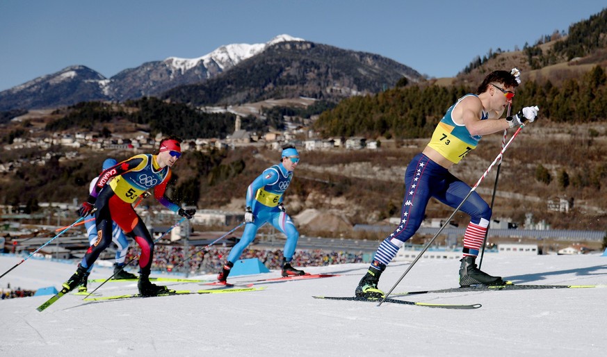epa12742302 John Steel Hagenbuch (R) of the USA competes in the Men's 4x7.5km Relay of the Cross-Country Skiing competitions at the Milano Cortina 2026 Winter Olympic Games, in Tesero, Italy, 15  ...
