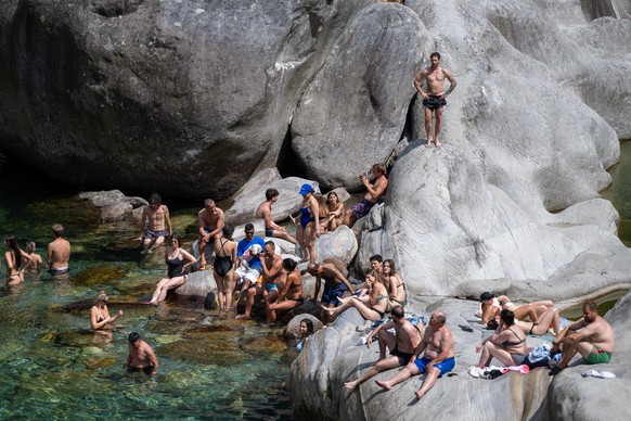 A few bathers seeking relief from the heat in the waters of the River Verzasca; in Ticino, a level 3 heatwave warning is in place due to high temperatures and sweltering heat; today the temperature re ...