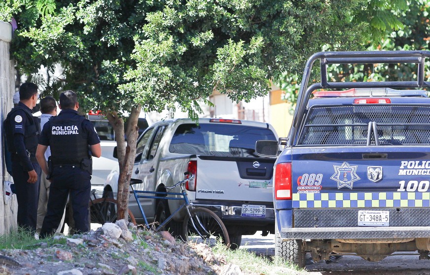 epa10064155 Police officers at the scene where at least six people were killed in an attack in Leon, Guanajuato state, Mexico, 10 July 2022. At least six people were killed this Sunday while they were ...