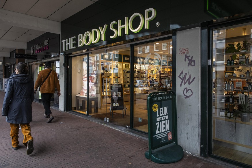epa11705173 Pedestrians pass by the Body Shop store in the center of Amsterdam, The Netherlands, 06 November 2024. The cosmetics store chain has been declared bankrupt by the court, while the stores w ...