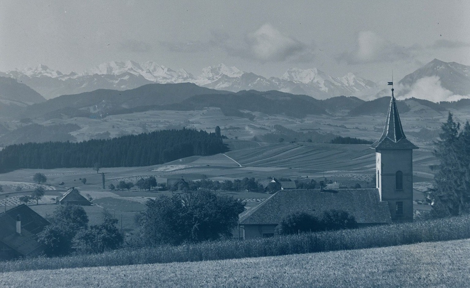 L’église de Heimenschwand avec vue sur les Alpes bernoises, vers 1920.