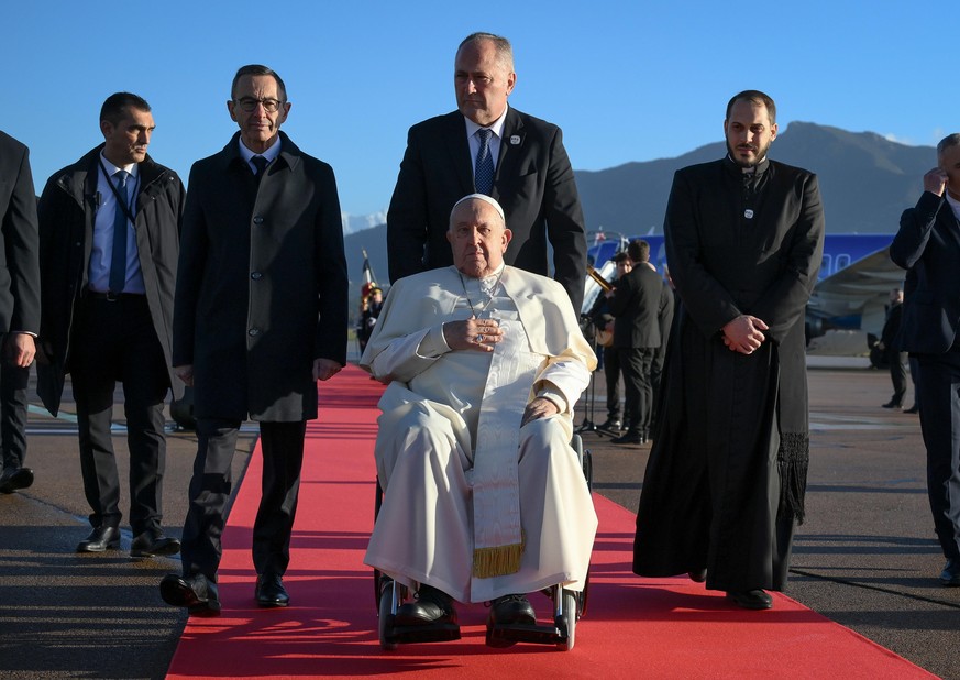epaselect epa11778100 Pope Francis arrives at Ajaccio airport, Corsica island, France, 15 December 2024. During his first papal visit to Corsica, Pope Francis will attend a Conference on Popular Relig ...