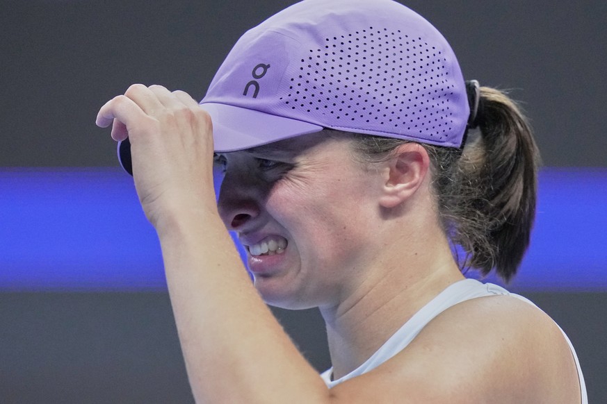 Iga Swiatek, of Poland reacts during the women&#039;s singles match against Emma Navarro, of the United States, in the China Open tennis tournament, at the National Tennis Center, in Beijing, Wednesda ...