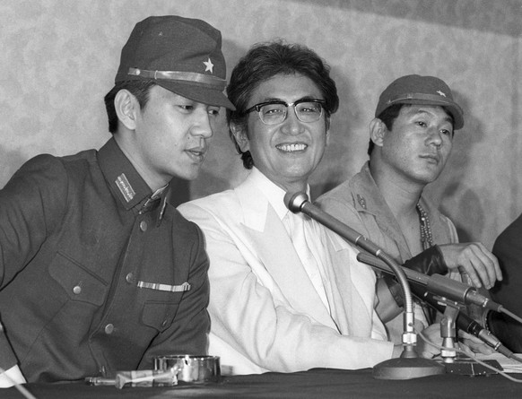 FILE - Japanese Director Nagisa Oshima, center, along with actors Ryuichi Sakamoto, left, and Takeshi Kitano, right, attends a press conference for his film &quot; Merry Christmas, Mr. Lawrence &quot; ...