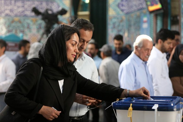 epa11443306 Iranians cast their votes in a polling station during the presidential election, in Tehran, Iran, 28 June 2024. Iran holds presidential elections on 28 June, following the death of late Ir ...