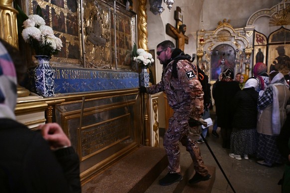 Andrei, the 49-year-old veteran of the Russian military campaign in Ukraine, prays to an icon in the Assumption Cathedral of the Pskovo-Pechersky monastery in the town of Pechory, some 50 kilometres o ...