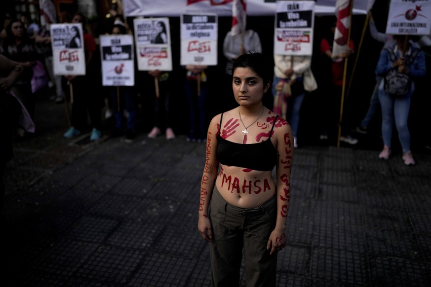Women protests against the death of Mahsa Amini, a woman who died while in police custody in Iran, in front of the Iranian embassy in Buenos Aires, Argentina, Tuesday, Sept. 27, 2022. Mahsa Amini was ...
