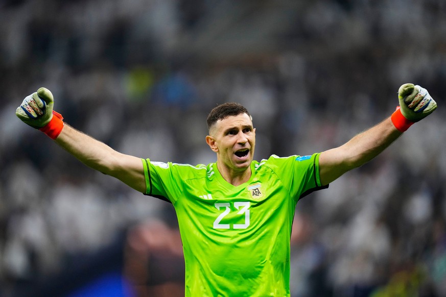 FILE - Argentina's goalkeeper Emiliano Martinez celebrates after he saved a penalty kick during the penalty shootouts in the World Cup final soccer match between Argentina and France at the Lusai ...