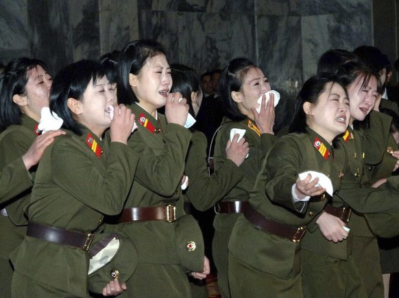 In this Tuesday, Dec. 27, 2011 photo released by the Korean Central News Agency and distributed in Tokyo Wednesday, Dec. 28, 2011 by the Korea News Service, North Korean woman military personnel mourn ...