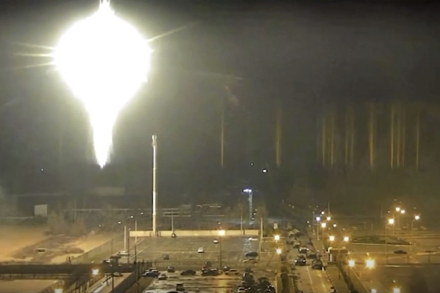 This image made from a video released by Zaporizhzhia nuclear power plant shows bright flaring object landing in grounds of the nuclear plant in Enerhodar, Ukraine Friday, March 4, 2022. Russian force ...