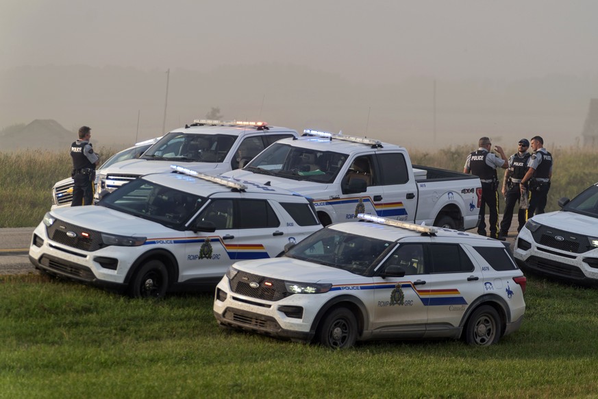 Police and investigators gather at the scene where a stabbing suspect was arrested in Rosthern, Saskatchewan on Wednesday, Sept. 7, 2022. Canadian police arrested Myles Sanderson, the second suspect i ...