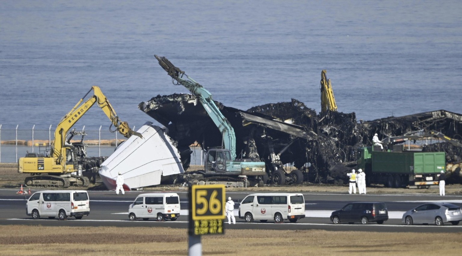 A removal work is underway at the site of a planes collision at Haneda airport in Tokyo Friday, Jan. 5, 2024. Cranes were dismantling the Japan Airlines Flight 516 Airbus A350 that caught fire after h ...