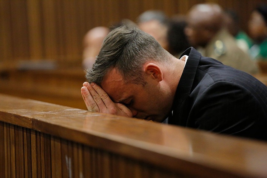 PRETORIA, SOUTH AFRICA - JUNE 14 : Oscar Pistorius puts his head in his hands as he sits inside the dock at the high court in Pretoria for his sentencing hearing at the high court in Pretoria on June  ...