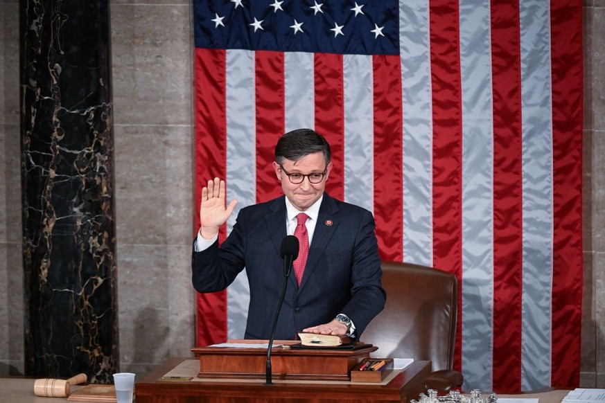 WASHINGTON, DC - OCTOBER 25: Speaker of the House elect Mike Johnson (R-LA) takes the oath in the House chambers as members of the House of Reprsentatives gather at the United States Capitol to vote f ...