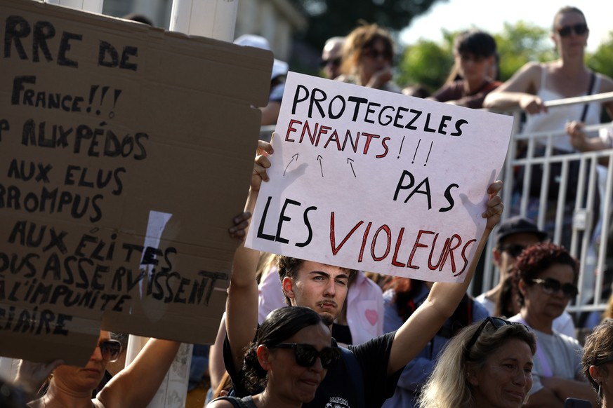 epa13024910 A protester carries a placard reading 'protect childrens not rapers' during a protest in front of the court house of Montpellier in Southern France, 08 June 2026. Several feminis ...