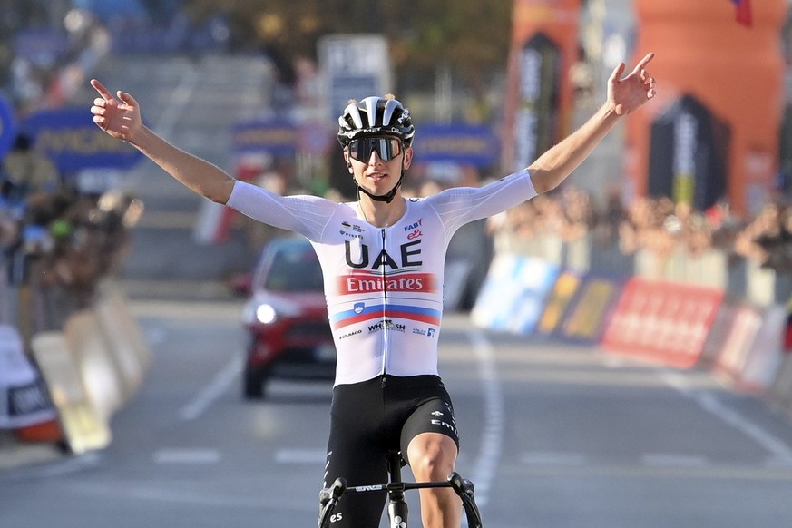 Tadej Pogacar celebrates as he crosses the finish line to win the tour of Lombardy cycling race, from Como to Bergamo, Italy, Saturday, Oct. 7, 2023. (Gian Mattia D&#039;Alberto/LaPresse via AP)